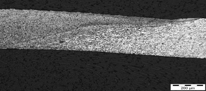 Figure7: Butt weld of 300μm thick sheets of aluminium alloy - Cross section showing transition from weld metal (left) to parent metal (right)